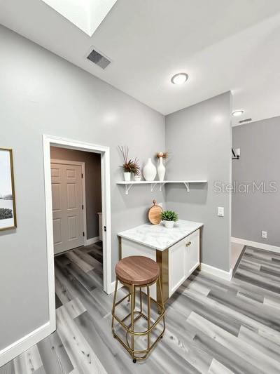 4218 San Rafael Ave, New Port Richey, FL 34655 - dining room with baseboards, light wood finished floors, and a skylight