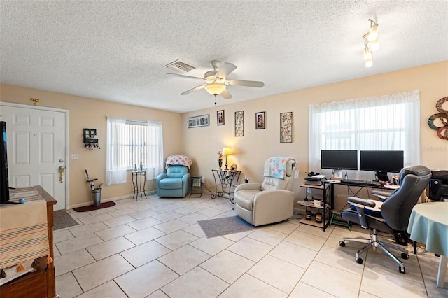 office area with light tile patterned floors, a textured ceiling, and ceiling fan