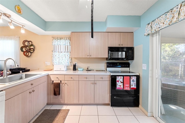 kitchen featuring light brown cabinetry, sink, light tile patterned floors, electric range, and white dishwasher