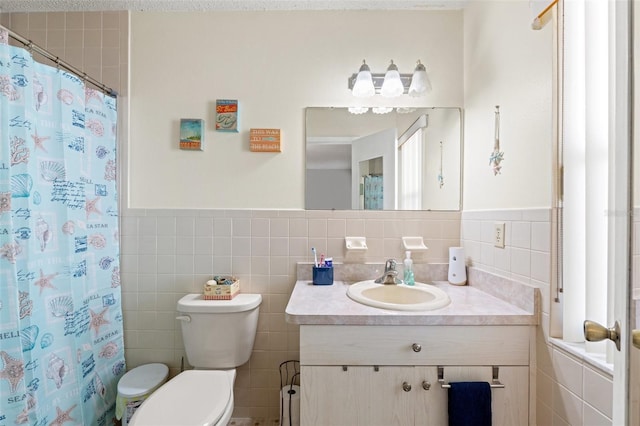 bathroom featuring vanity, tile walls, and curtained shower