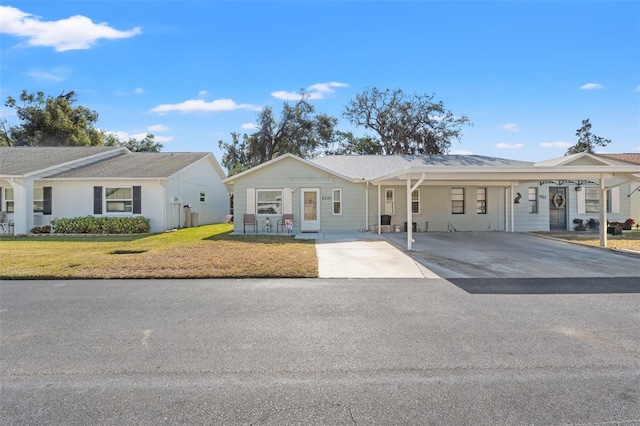 ranch-style home featuring a carport and a front lawn