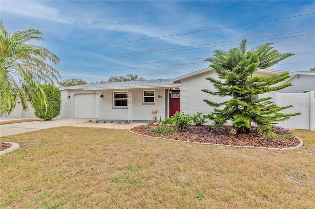 ranch-style home with a garage and a front lawn