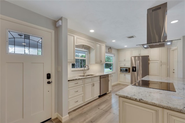 kitchen featuring sink, light hardwood / wood-style flooring, stainless steel appliances, light stone countertops, and island exhaust hood