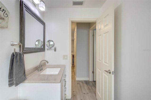 bathroom with vanity and hardwood / wood-style floors