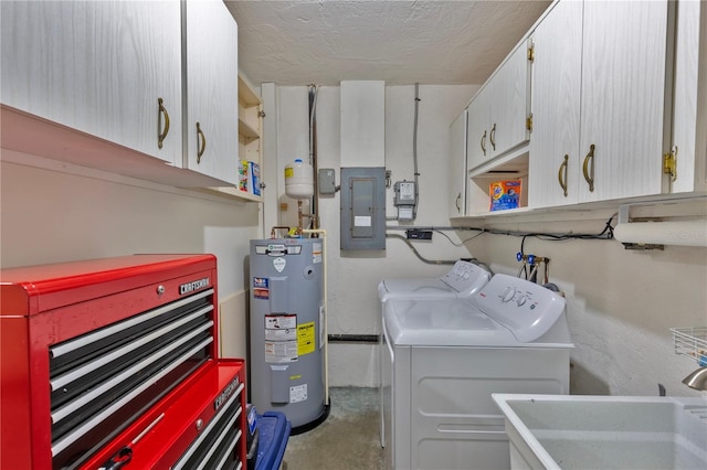 laundry area with sink, water heater, electric panel, cabinets, and washing machine and clothes dryer