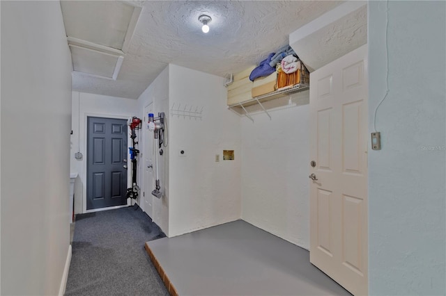 interior space with dark carpet and a textured ceiling