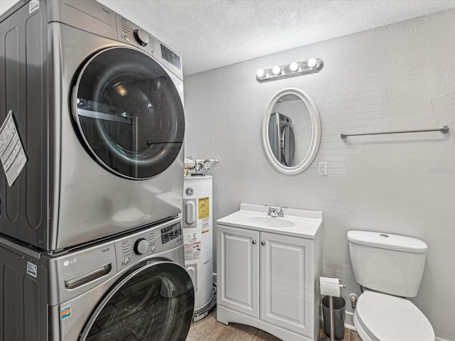 laundry room with stacked washer / drying machine, sink, a textured ceiling, light wood-type flooring, and water heater