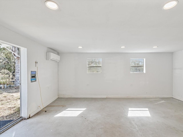 empty room featuring a wall mounted air conditioner and plenty of natural light