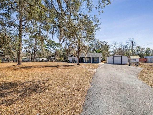 ranch-style home featuring an outbuilding and a garage