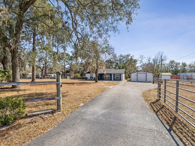 view of front of house featuring a garage and an outdoor structure