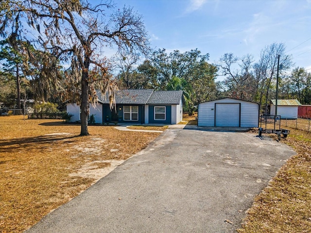 ranch-style house featuring an outbuilding and a garage