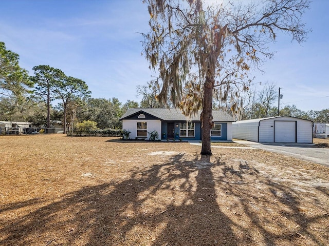 view of front of property featuring a garage and an outdoor structure