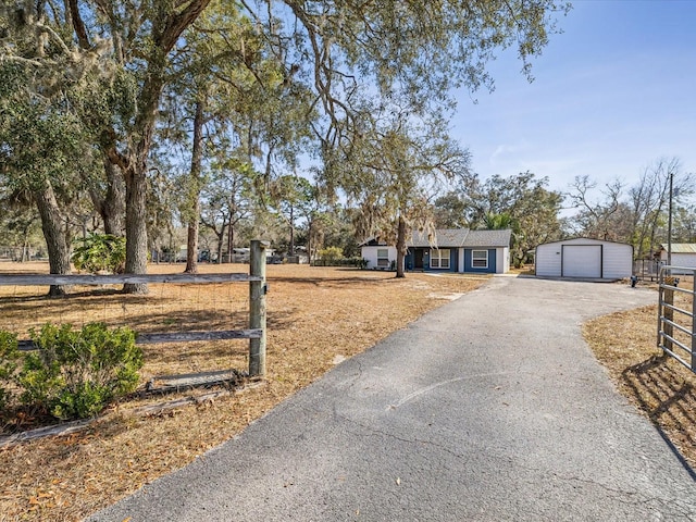 view of front of property featuring a garage and an outdoor structure