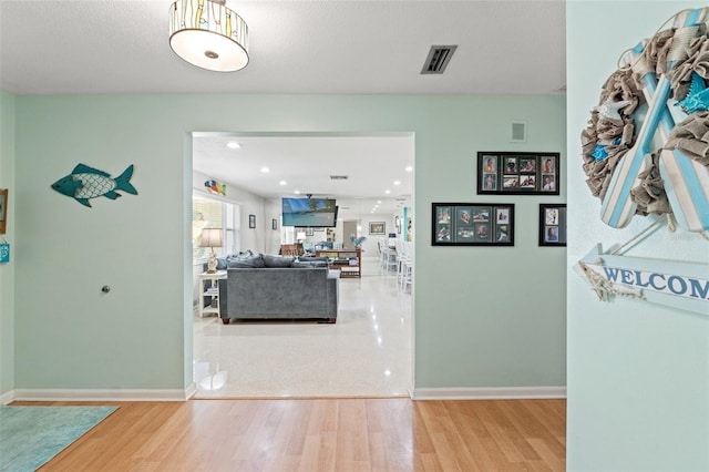 corridor featuring hardwood / wood-style floors