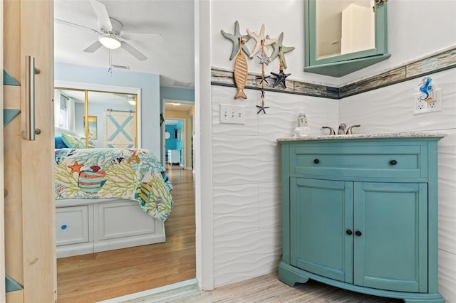 bathroom with vanity, hardwood / wood-style floors, and ceiling fan