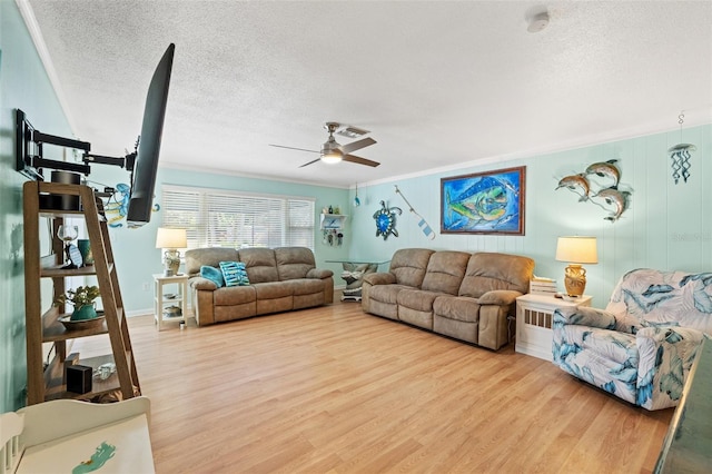 living room with ceiling fan, crown molding, a textured ceiling, and light hardwood / wood-style floors