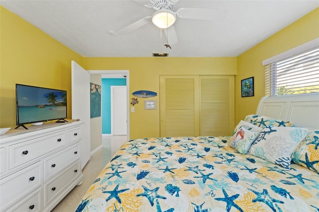 carpeted bedroom with a closet and ceiling fan