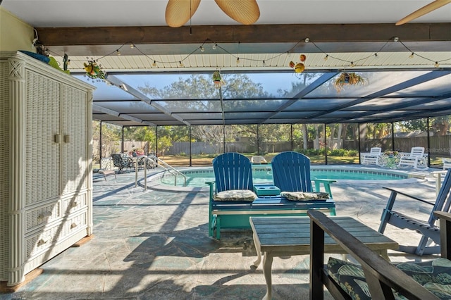 view of patio featuring ceiling fan, a fenced in pool, and glass enclosure