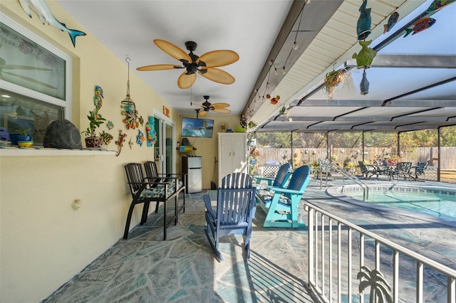 view of patio featuring a fenced in pool, ceiling fan, and glass enclosure