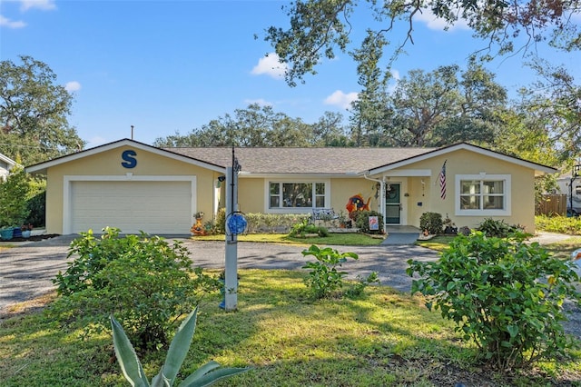 ranch-style house featuring a garage and a front yard