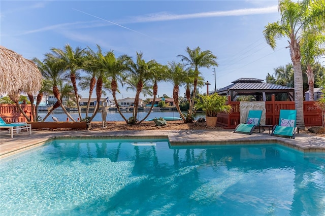 view of swimming pool featuring a gazebo, a fenced in pool, fence, and a patio