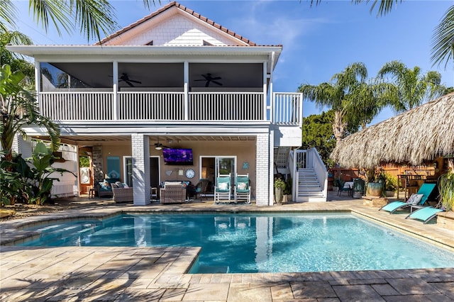 rear view of house with an outdoor hangout area, a patio area, a balcony, and ceiling fan