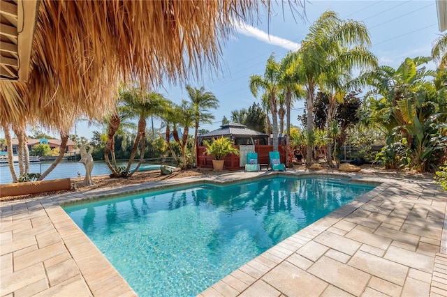 view of pool with a gazebo and a water view