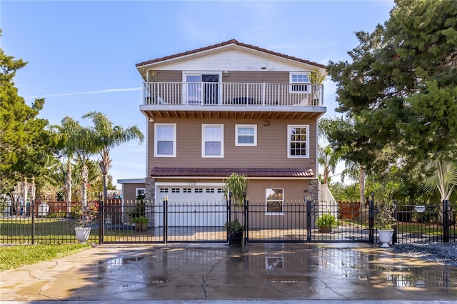 view of property with a garage and a balcony