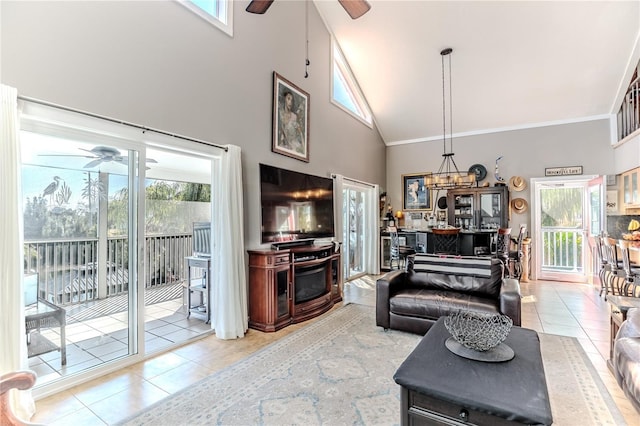 tiled living room with crown molding, high vaulted ceiling, and ceiling fan