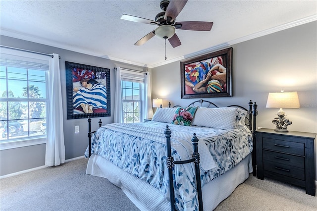 carpeted bedroom with multiple windows, ceiling fan, crown molding, and a textured ceiling