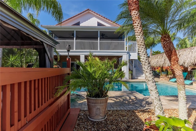 back of house with ceiling fan and a patio