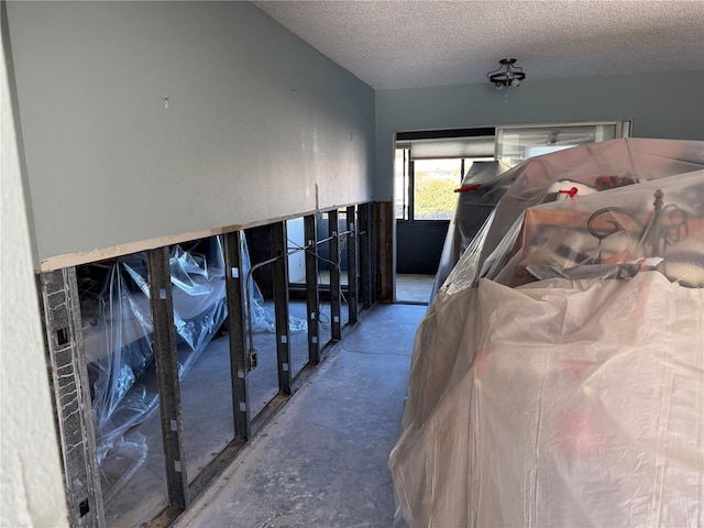 misc room with a textured ceiling and concrete floors