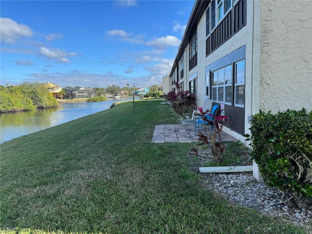 view of yard with a patio area and a water view