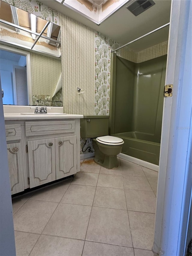 full bathroom featuring tile patterned flooring, vanity, shower / tub combination, and toilet