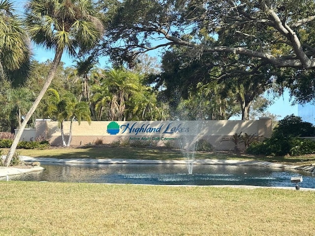 view of community with a yard and a water view