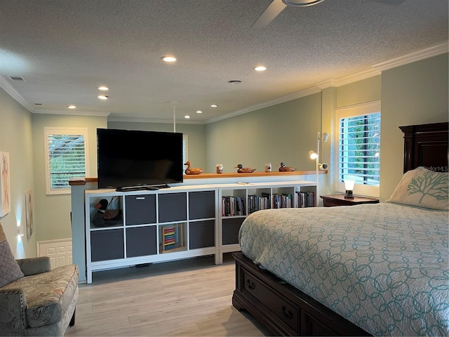 bedroom featuring ornamental molding, multiple windows, and light hardwood / wood-style flooring