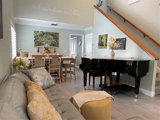 living room featuring a high ceiling and ornamental molding