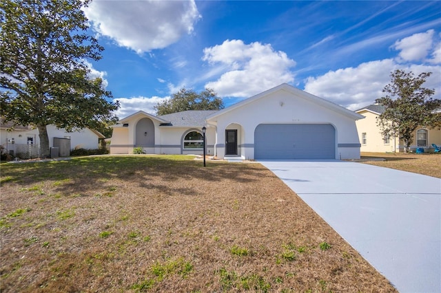 single story home with a garage and a front yard