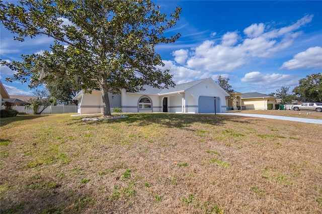 ranch-style house featuring a garage and a front lawn