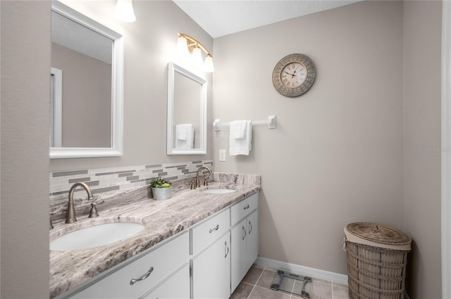 bathroom with tasteful backsplash, vanity, and tile patterned flooring