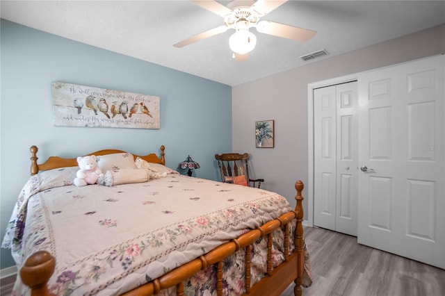 bedroom featuring ceiling fan, light hardwood / wood-style floors, and a closet