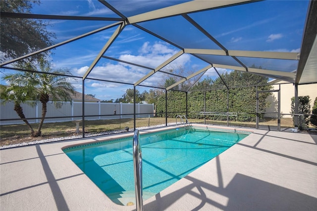 view of pool featuring a patio and glass enclosure