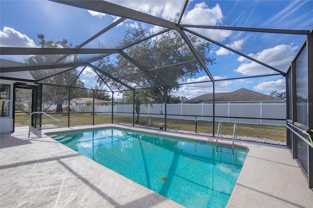 view of swimming pool with a lanai, a patio area, and a lawn