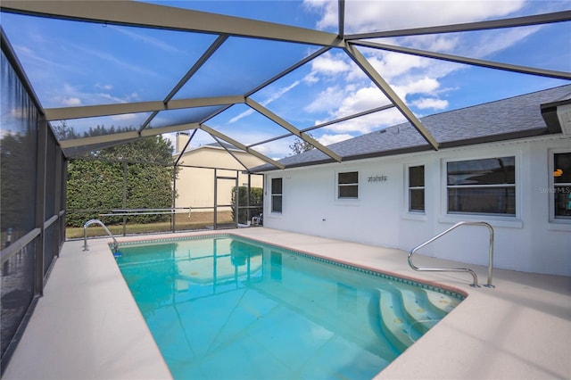 view of pool with a patio and glass enclosure