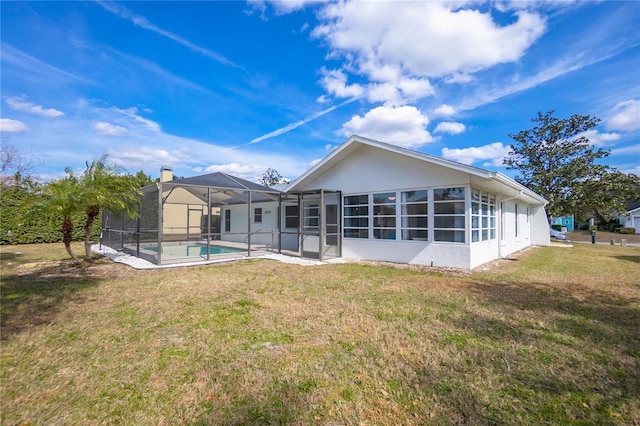 rear view of house with a yard, a lanai, and a patio area