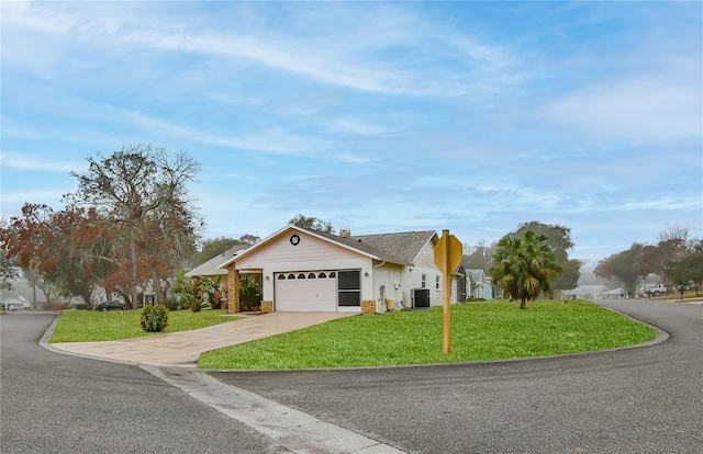 ranch-style home with central AC unit, a garage, and a front yard