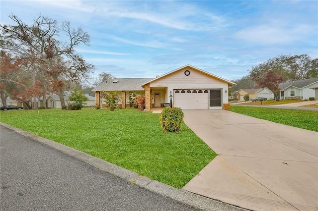 single story home featuring a garage and a front lawn