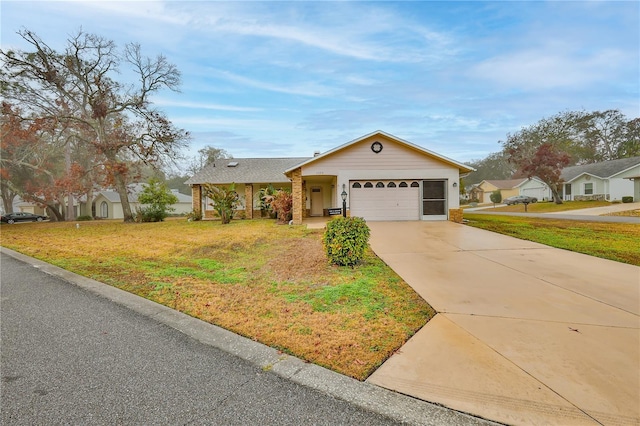 single story home with a garage and a front lawn