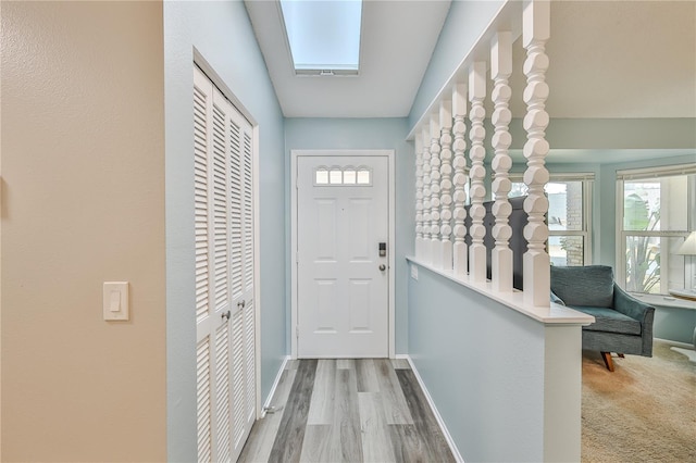 entryway featuring hardwood / wood-style floors and a skylight