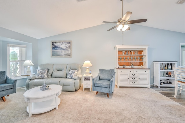 carpeted living room with ceiling fan and lofted ceiling